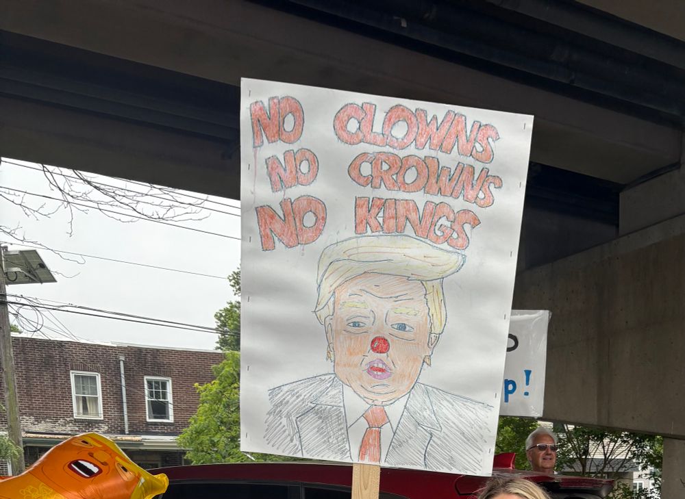 Poster of drawing of DJT with a red clown nose. No clowns, No crowns, No kings