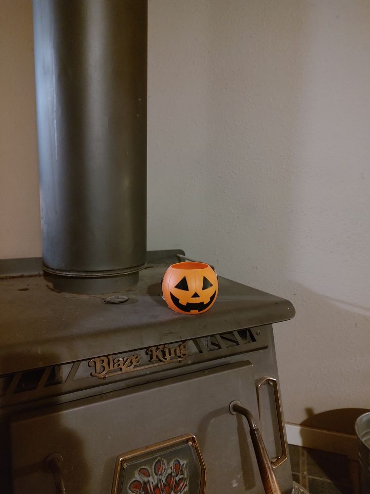 Picture of a tiny orange plastic jack-o'-lantern candy bucket 