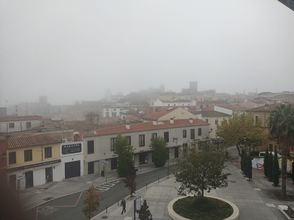 A foggy view of the old town of Cáceres in the morning.