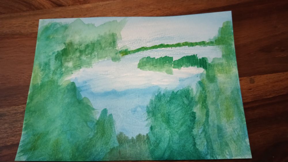 A photo of a watercolor painting (fairly abstract) of a bright blue lake and sky encircled by trees in different shades of green.