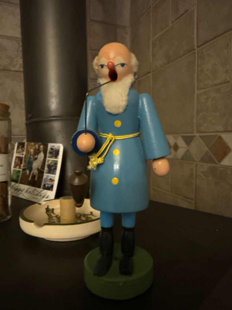 Incense holder that looks like an old man smoking a pipe