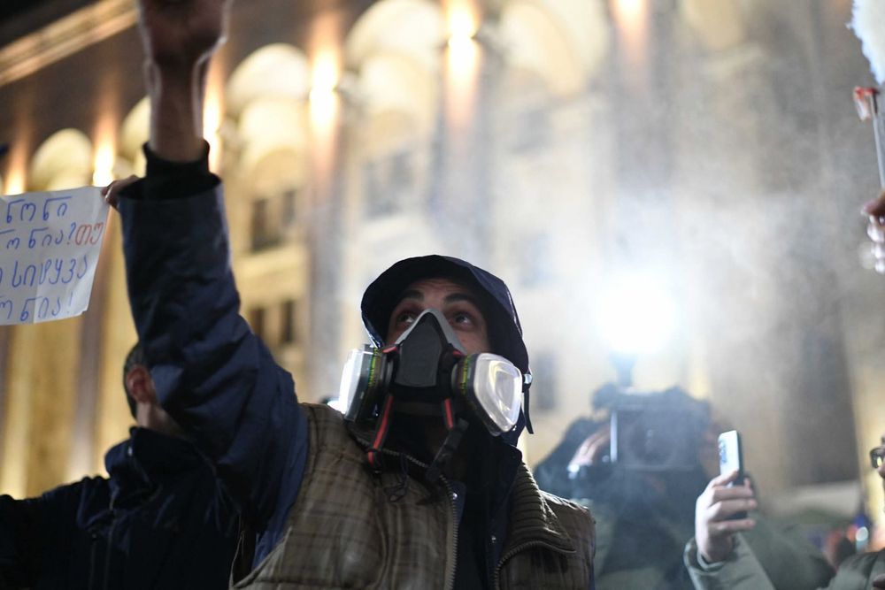 Photo of young woman from today protest in Georgia, she covers her face with protective gear (gas mask?) even now this is punishable with jail time by a draconian law adopted by illegitimate  government