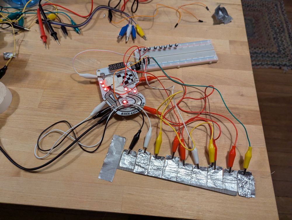 Kernelcon badge with the track wired into a straight line. 