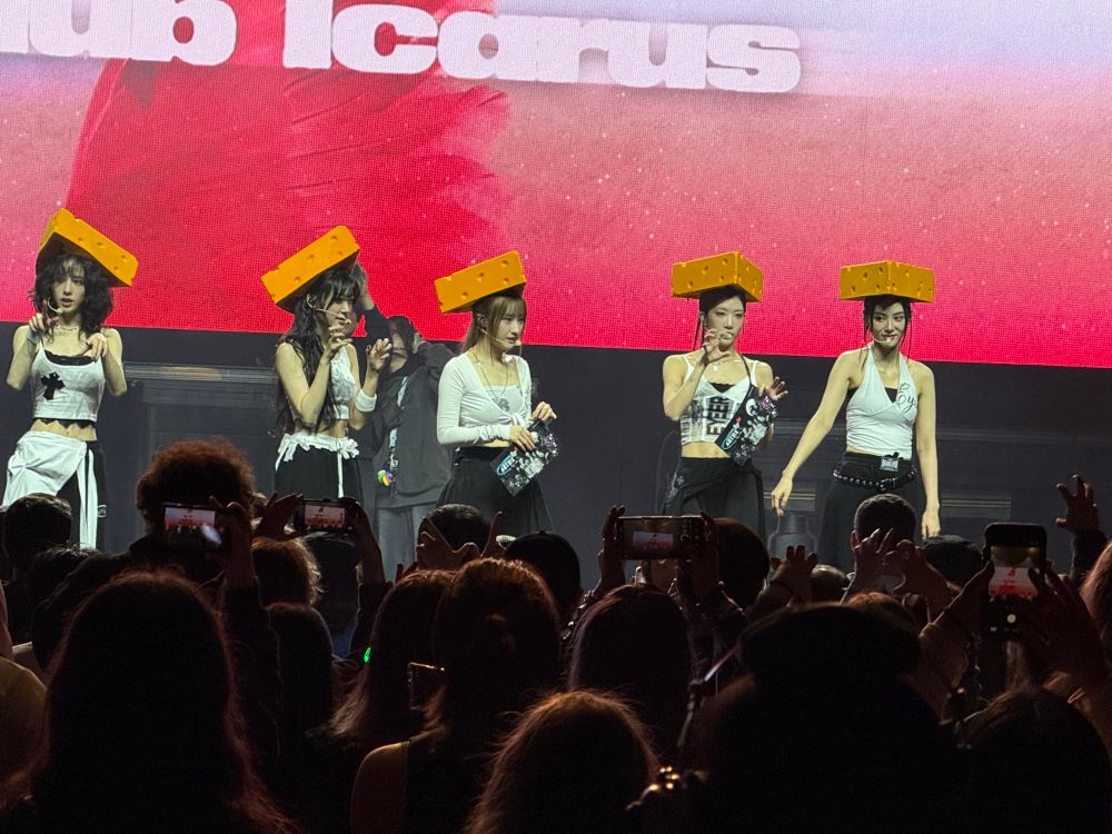 the kpop group artms wearing wisconsin cheese hats