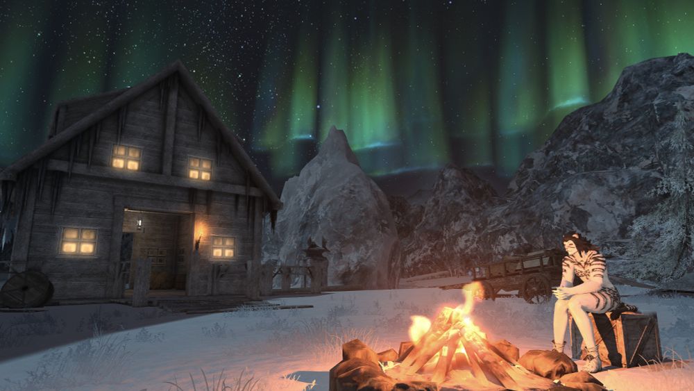 Ane Mora@Famfrit is sitting on a wooden crate in front of a campfire in the Coerthas Western Highlands. There is snow on the ground and a log cabin behind her. The green glow of the Aurora Borealis is visible in the night sky in the distance. She isn't cold.