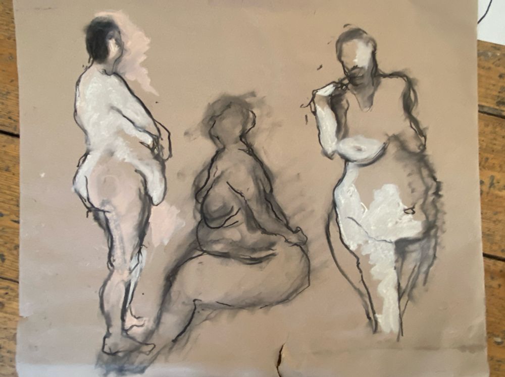 A selection of experimental life drawings on brown paper. 3 large figures drawn with charcoal and pale skin-toned chalk. The lines are smudged and smeared giving the appearance of movement. 