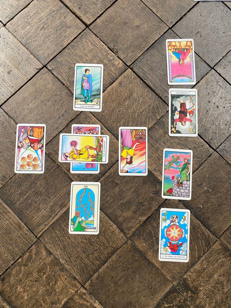 A Celtic tarot spread on a wooden church floor