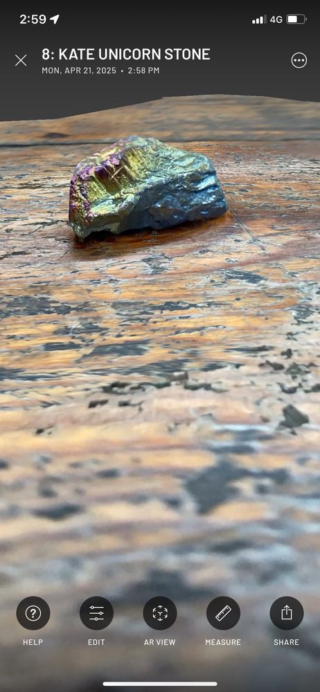 A screen shot from a phone showing a 3D digital scan of a rainbow-tinged stone.