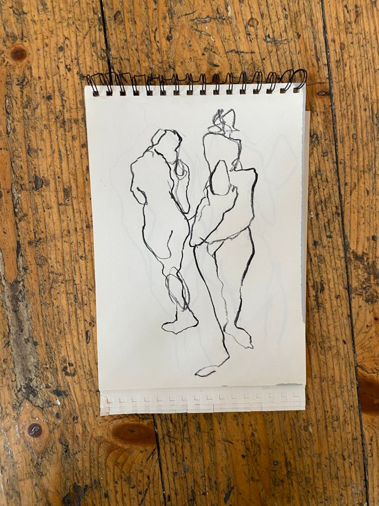 A continuous line drawing on white paper of two intertwined figures walking