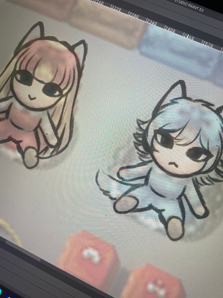 A screen drawing tablet with clip studio paint, open and sketches of two chibis in rpg maker style