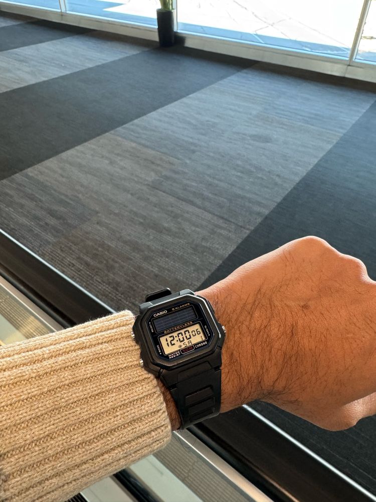 A close up photo of a solar powered vintage Casio watch on a wrist. 