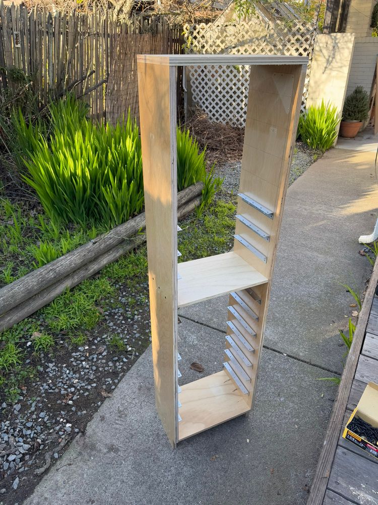 A free standing shelf partially assembled