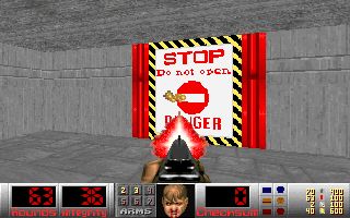 Screenshot of The Sky May Be. A large door in front of the player is labeled "STOP, Do not open, DANGER", and festooned with caution stripes and a large do-not-enter sign.