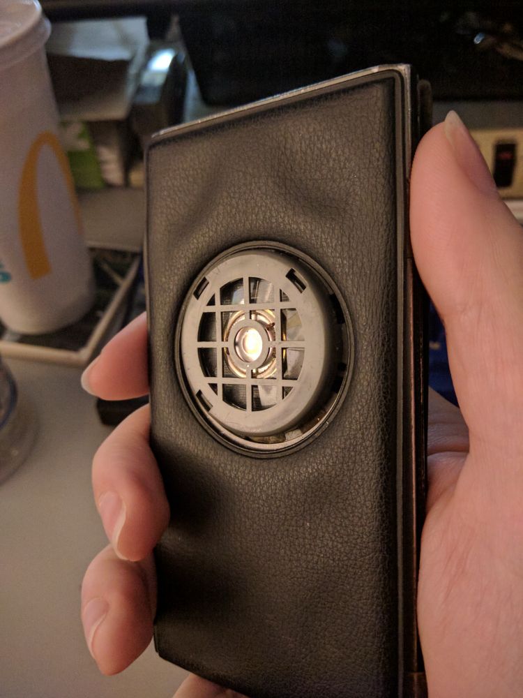 To use the device to dial a number, you hold this transducer up to the mouth piece of your plain old landline telephone and press the Dial button. The device then emits the same tones as a touch tone phone, in the sequence that makes up that number.
