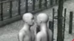 two nondescript 3d models of humans very close and facing each other