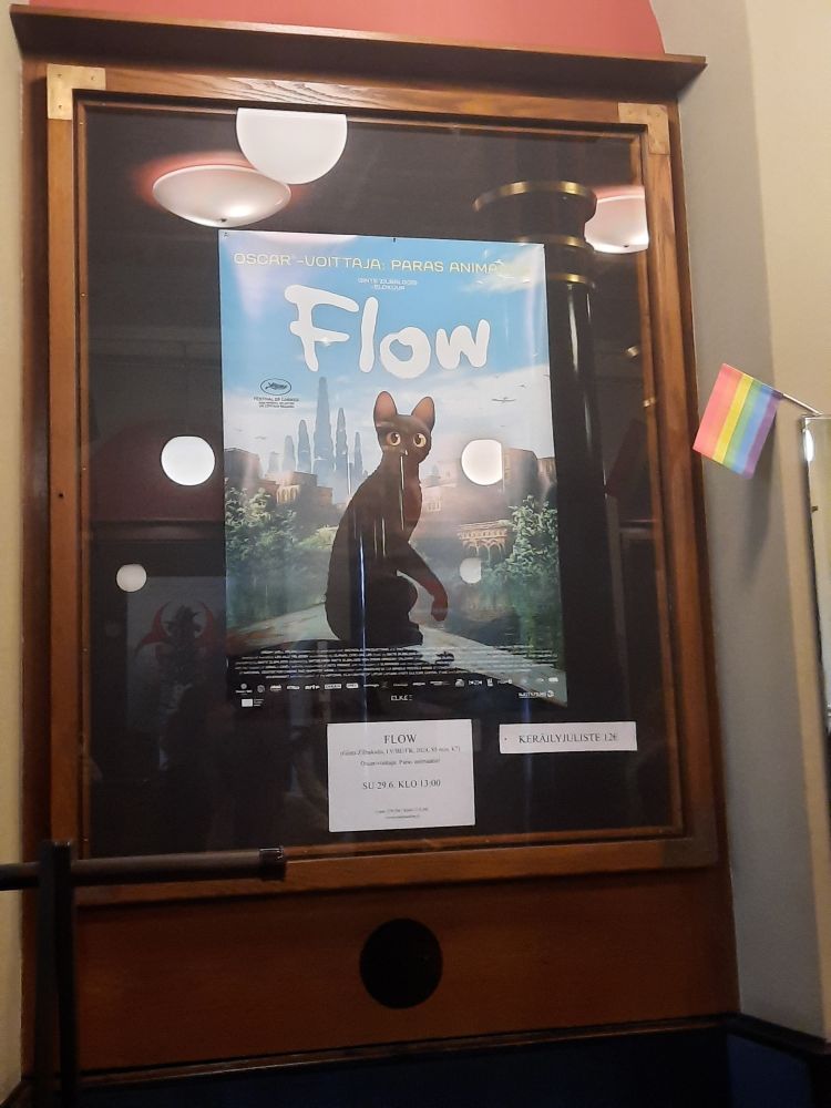 poster for FLOW with a small rainbow flag next to it