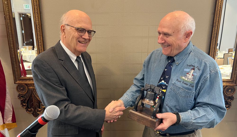 Guy Greve, left, presents the Liberty Bell Award to Don Comtois.