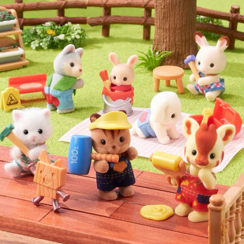 Product photo of Sylvanian Families blind bag series 赤ちゃん工作だいすきシリーズ (Babies Love Crafting). A Persian cat baby holds a hammer next to a very dangerous looking toy made of wood and bent nails, a squirrel baby wearing overalls holds an oversized rubber mallet marked “100t” and is wearing a yellow visor that definitely is not OSHA compliant, a giraffe baby is holding a paint roller that has created a puddle, a baby husky has just ignored a wet paint sign and sat on a freshly painted bench so he now has a VERY UNFORTUNATELY RED splotch on his butt, a newborn milk baby is drowning in a paint can while another lop rabbit baby crawls ominously towards an open toolbox, and a chocolate rabbit baby in the background holds a small mallet next to a stoop we’re supposed to believe she just built. 