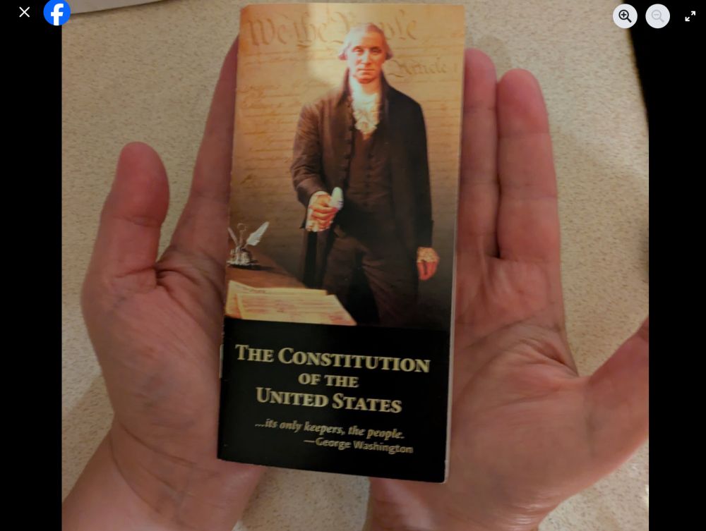 Cover of the Constitution of the United States held in two open hands.