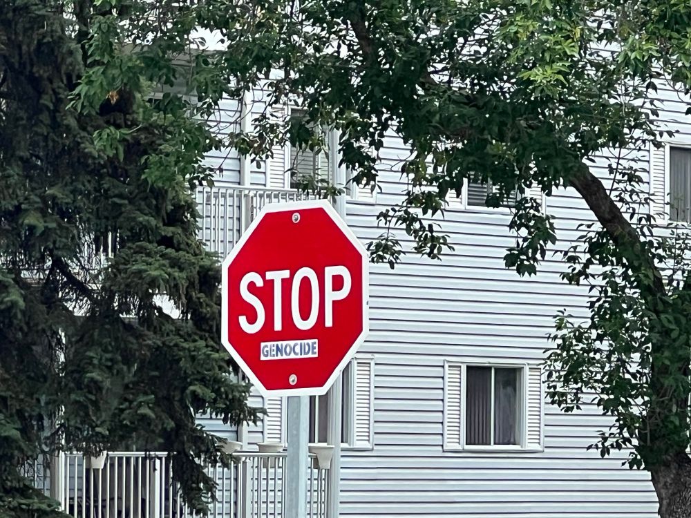 Stop sign that says “STOP Genocide”