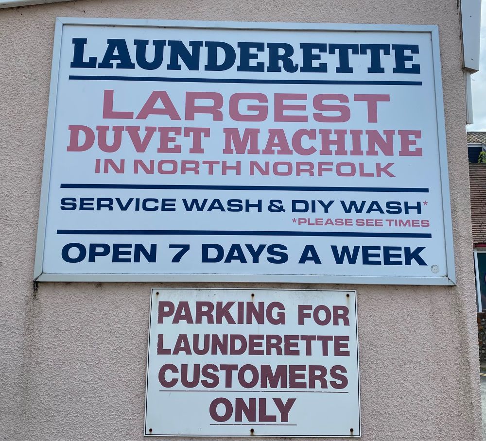 Sign for a launderette advertising they have the largest duvet cleaning machine in north norfolk.