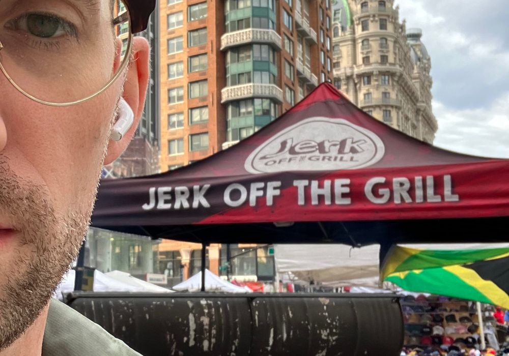 an image of a food stand in new york called "jerk off the grill"