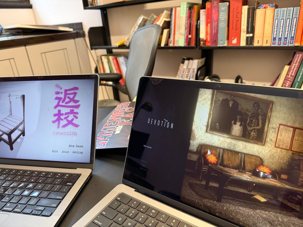 Picture of two laptops playing the horror games Detention and Devotion.