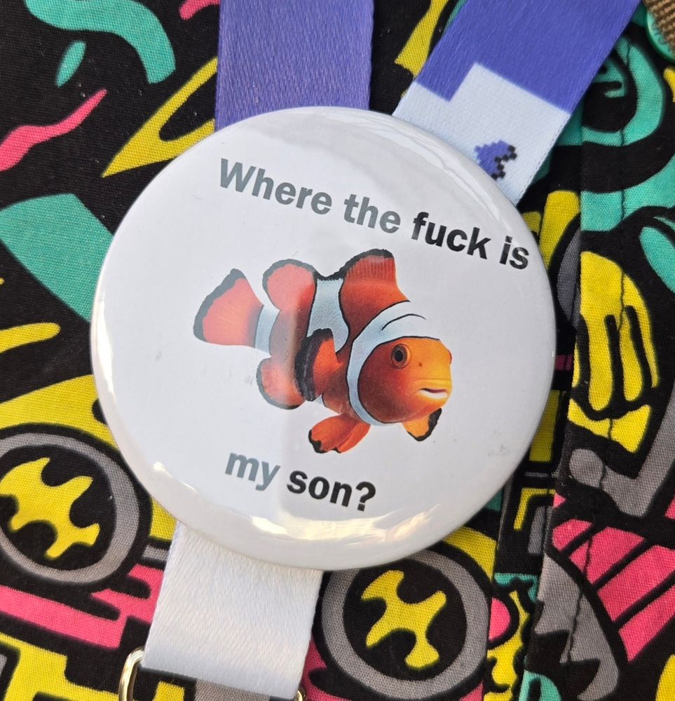 A pin featuring a photo of a clownfish and the text 