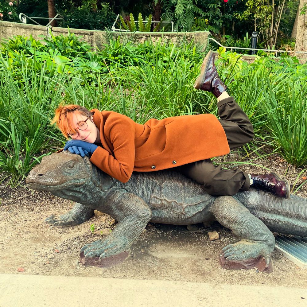 Me happily posing on top of a giant lizard statue. I can’t remember the name of it. 🥲
