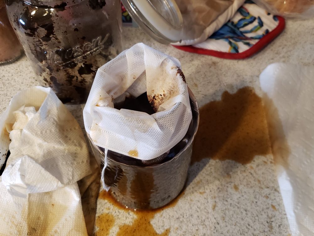 a lined jar of cold brew has a copious amount of cold brew on the counter, outside of the jar, which is not where it is meant to be