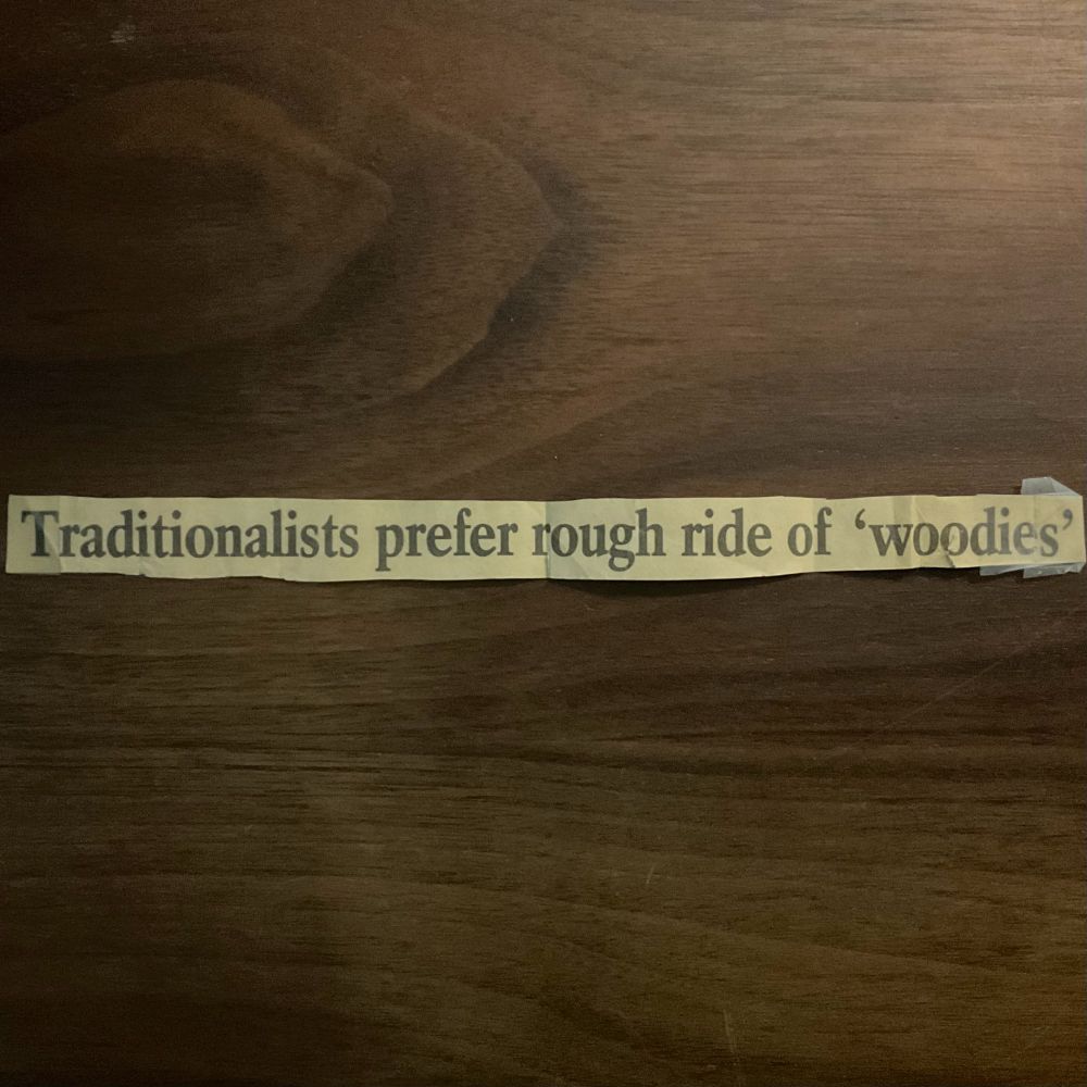 old newspaper headline clipped and laying on wood desktop reading:

Traditionalists prefer rough ride of 'woodies'