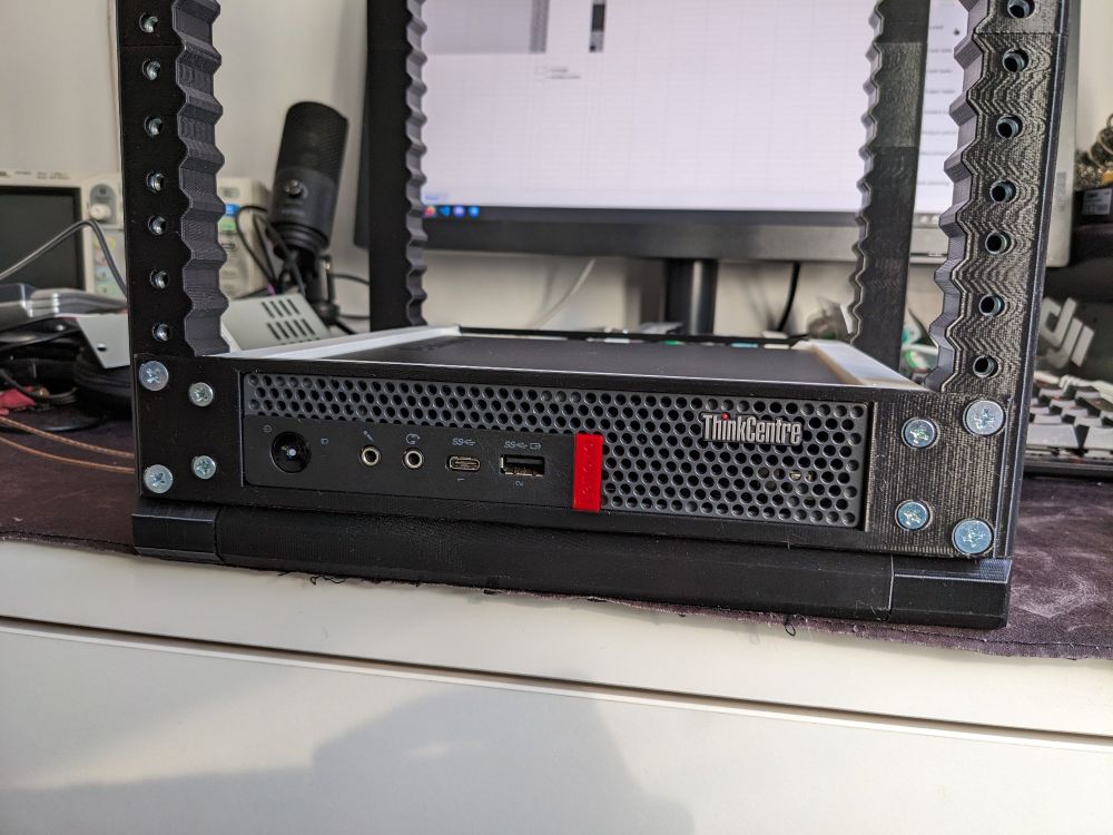A Lenovo Thinkstation M920 inside a 3D printed rack.