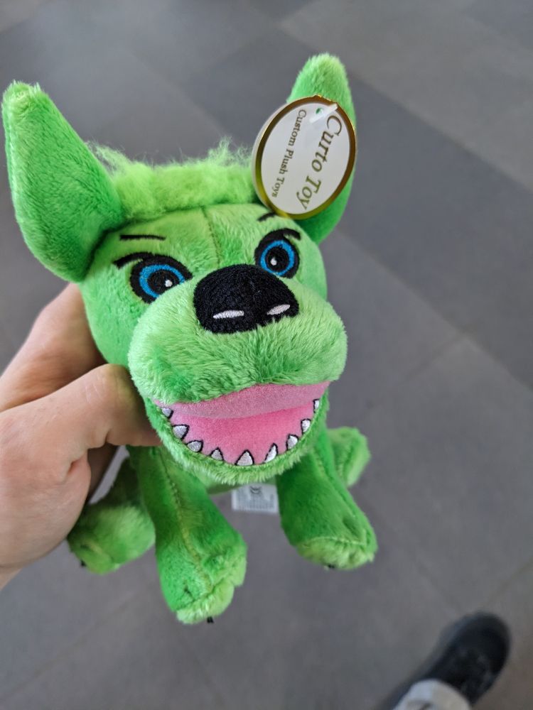 A plush of the thorlabs green mascot dog.