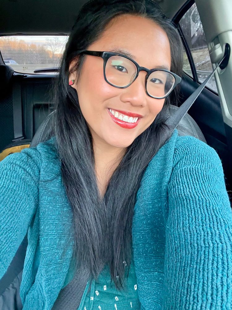 selfie of me 
asian woman with black hair and glasses and blue green sweater 
