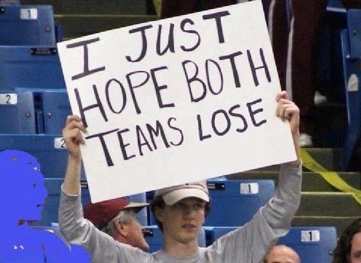A person holding up a sign saying “I want both teams to lose”.
