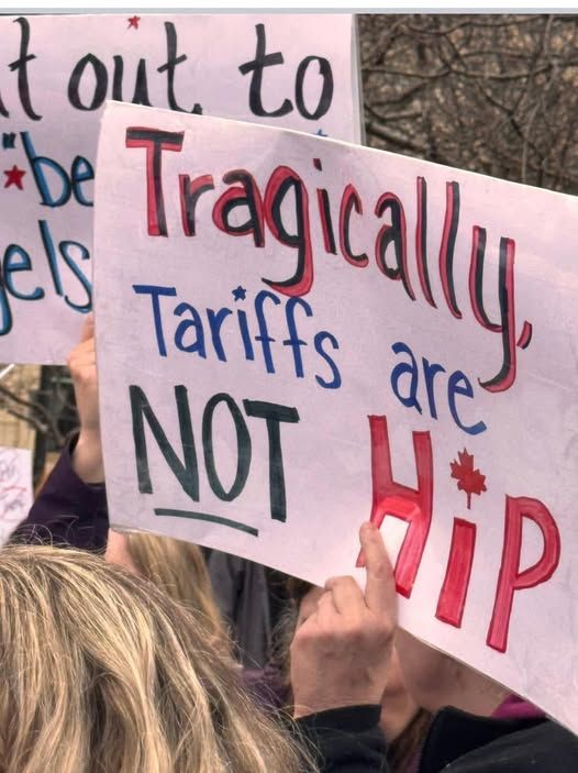 Protest sign reads Tragically, Tariffs are NOT Hip