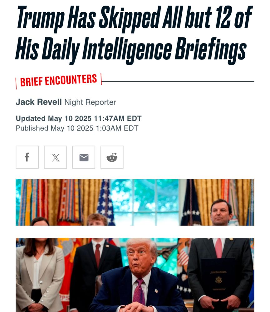 Trump sitting at a desk with a stupid look on his face.
