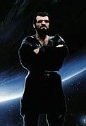 Villain Non from the original Superman movies. A large, brooding man in black vinyl with a heavy black beard. His arms are crossed. The background is the arc of a planet against stars.