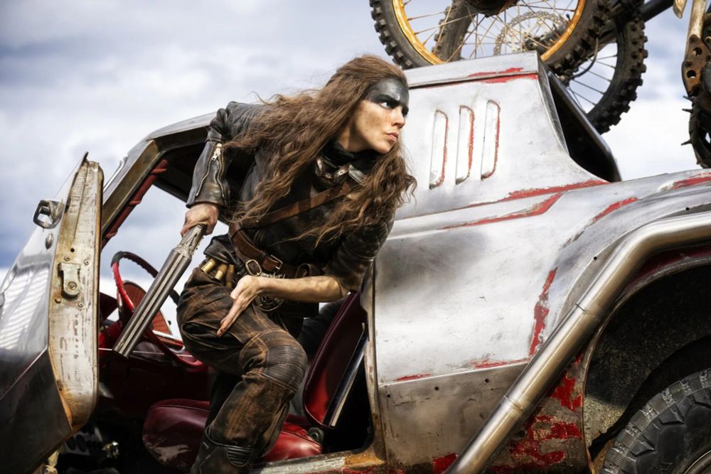 Furiosa aboard one of the hot rods from the film "Furiosa: A Mad Max Tale"