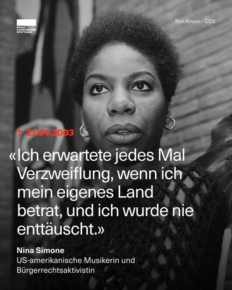Ein Schwarz-Weiß-Foto der US-amerikanischen Musikerin und Bürgerrechtsaktivistin Nina Simone. Sie blickt ernst und direkt nach vorne, trägt kreisförmige Ohrringe und einen dunklen Strickpullover. Im Hintergrund sind eine gemusterte Wand und ein unscharfes Bild oder eine Statue zu sehen.
Links im Bild steht das Todesdatum in Rot: „† 21.04.2003“. Darunter ist ein Zitat von ihr eingeblendet:
„Ich erwartete jedes Mal Verzweiflung, wenn ich mein eigenes Land betrat, und ich wurde nie enttäuscht.“
Unter dem Zitat steht ihr Name und ihre Beschreibung: Nina Simone – US-amerikanische Musikerin und Bürgerrechtsaktivistin. Oben links ist das Logo der Rosa-Luxemburg-Stiftung, oben rechts ist der Bildnachweis: „Ron Kroon – CC0“.