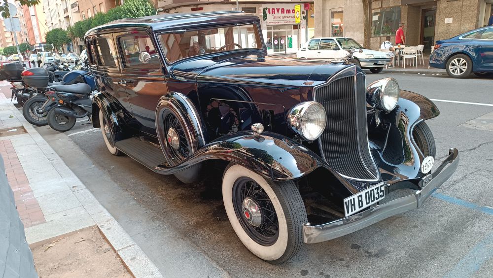 A very well maintained black vintage car (from the 30's maybe? 20's?)
