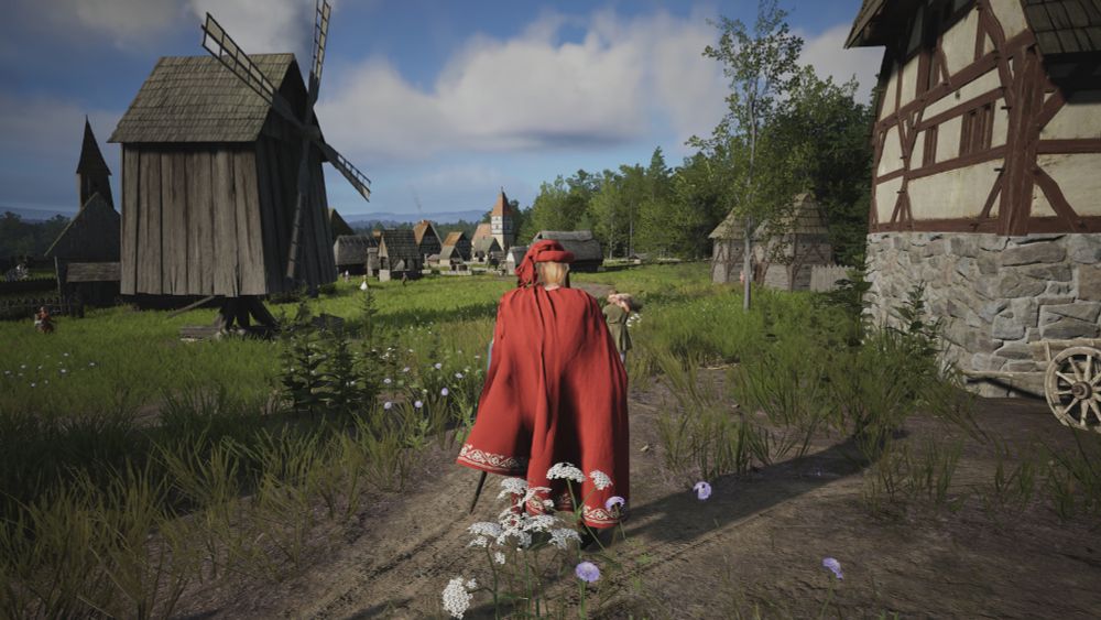 Free roam mode of the game where you can visit your towns in third person. Here we see a wooden windmill and some farms. A town with a couple of churches can be seen in the background.