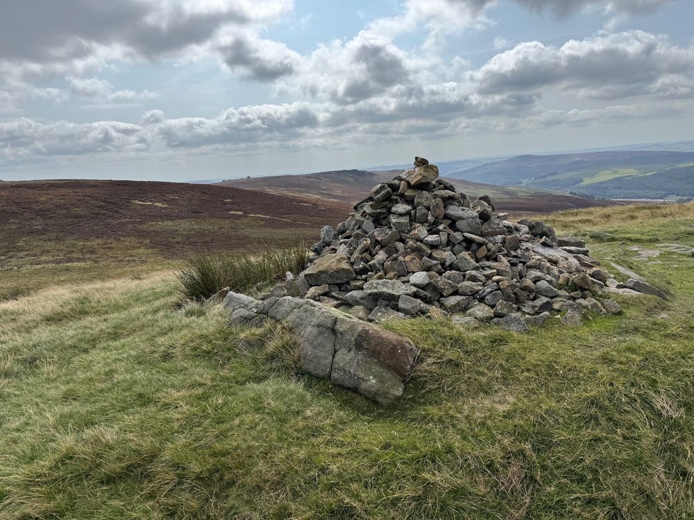 The Lost Lad cairn. Commemorates the demise of a late 17th century shepherd boy from Derwent who went out one evening to collect the family's sheep flock, but was caught in a blizzard. He sheltered in the lee of a rock, but sadly didn’t survive. His remains were discovered the following spring when the snow had melted. As a tribute, the cairn was begun on the spot. Present-day shepherds and walkers still add to the cairn, and it acts as a way marker. It is said his ghost can sometimes be seen in wintry weather. Last claimed sighting in 1993