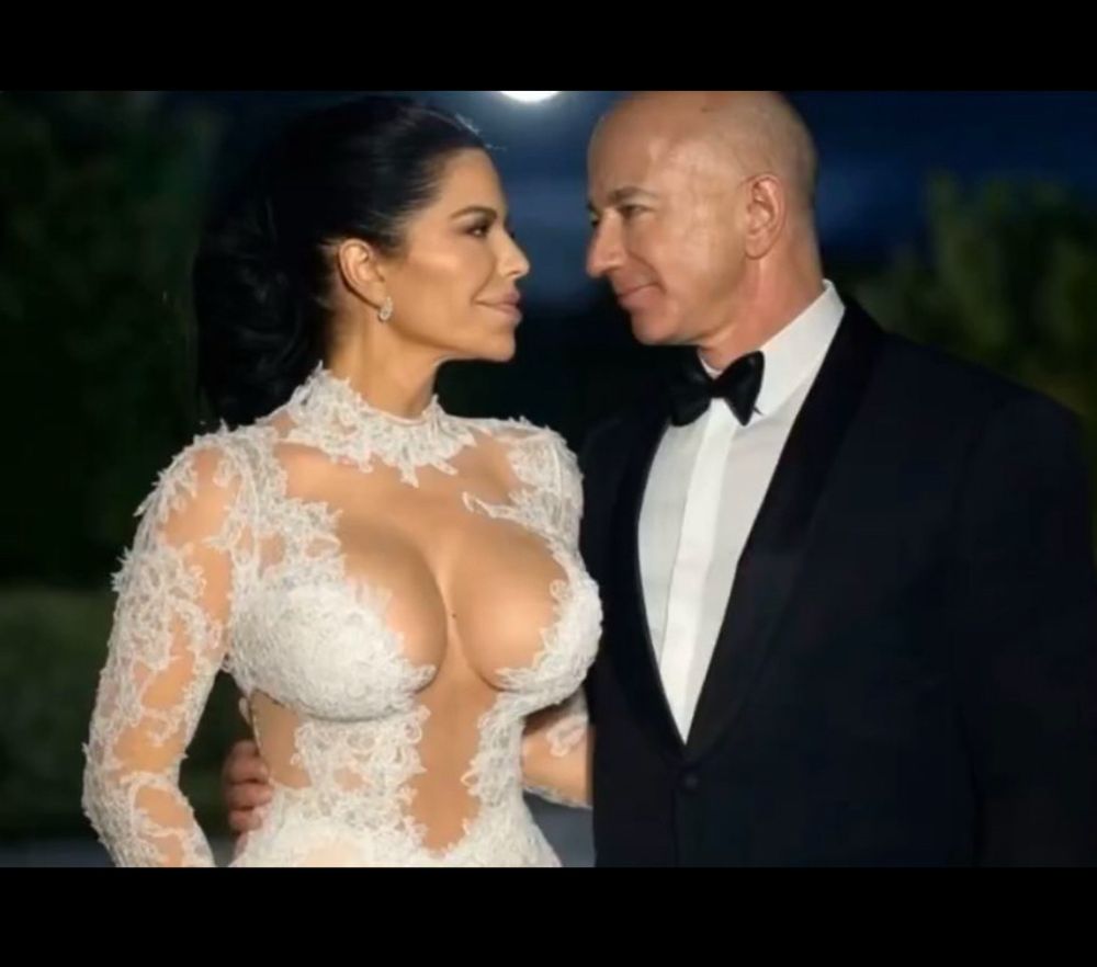 Jeff Bezos & Lauren Sanchez with her dress open revealing her massive plastic........bowling balls 