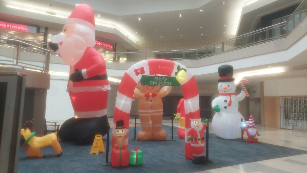 Inside the Burnsville Mall, a bunch of large Christmas-themed inflatables are set up. A Santa, a reindeer, a gingerbread man, a snowman, and a candy cane arch.