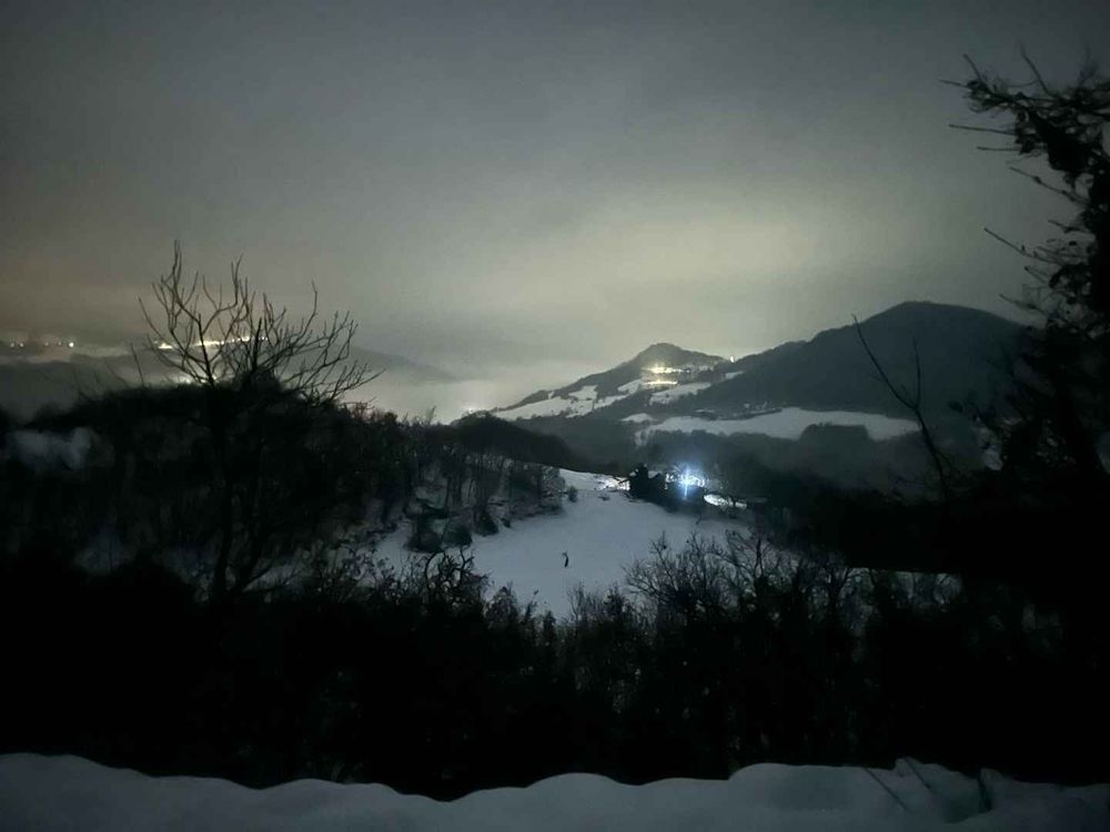 The destination framed by snow banks, clouds, and dark trees