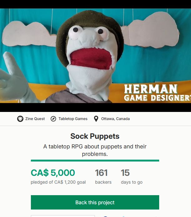 A still frame from a video depicts a puppet mid-sentence, with a title card that reads "Herman - Game Designer?" Underneath the video, there are project stats: Sock Puppets. 161 backers, 15 days to go, and $5000 pledged exactly.