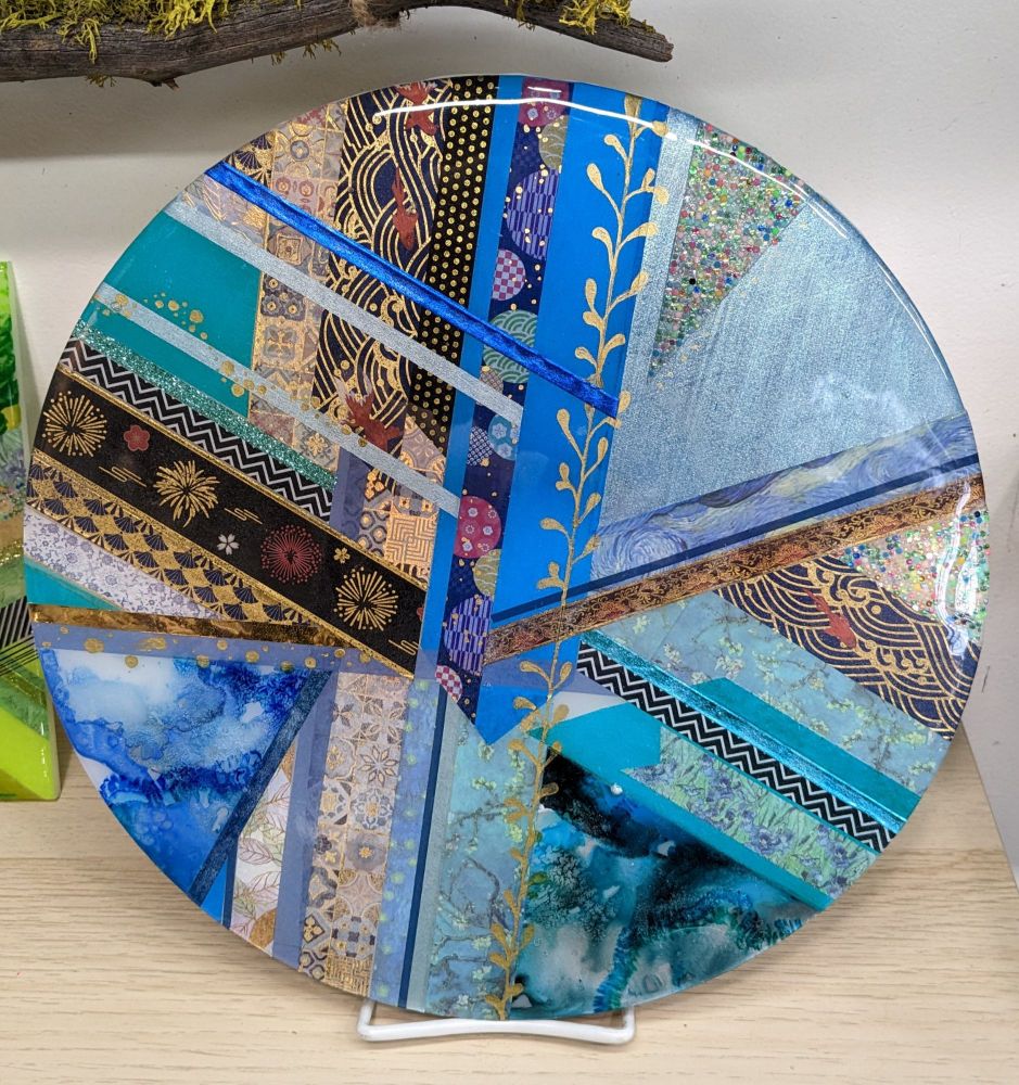 Study is blue made with alcohol ink, washi tape, and markers on acrylic disc. 