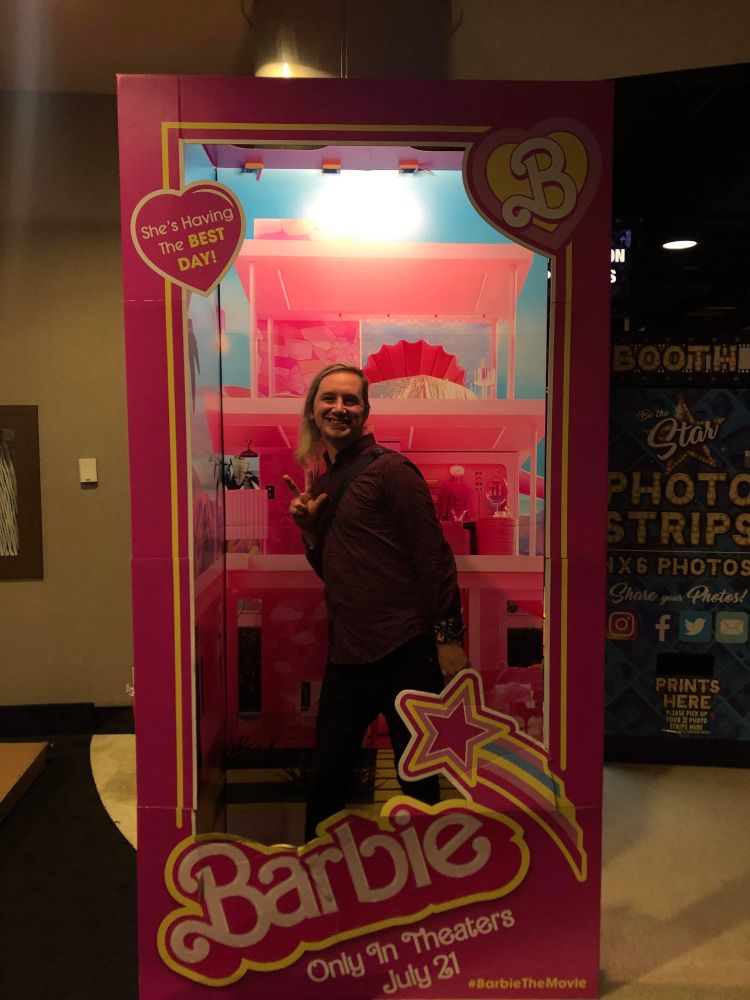 JV standing in the Barbie box