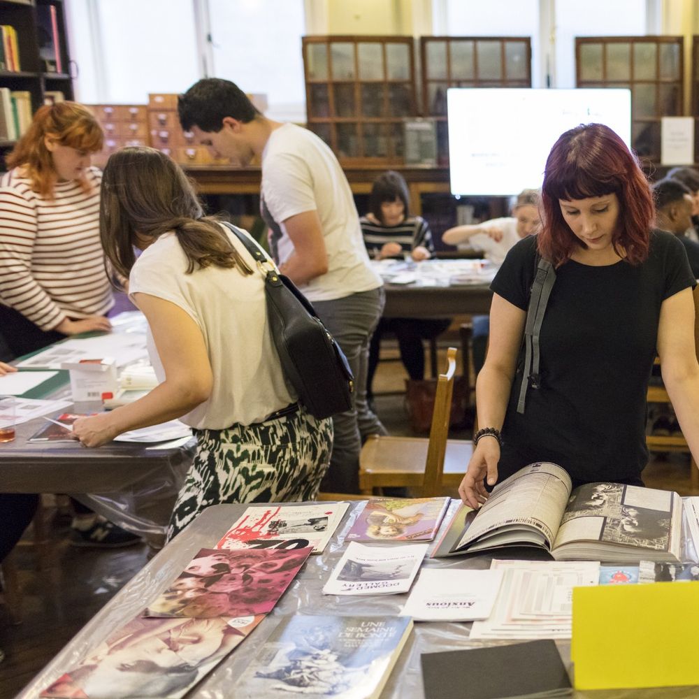 A group of people looking through archive material at Bishopsgate Institute.